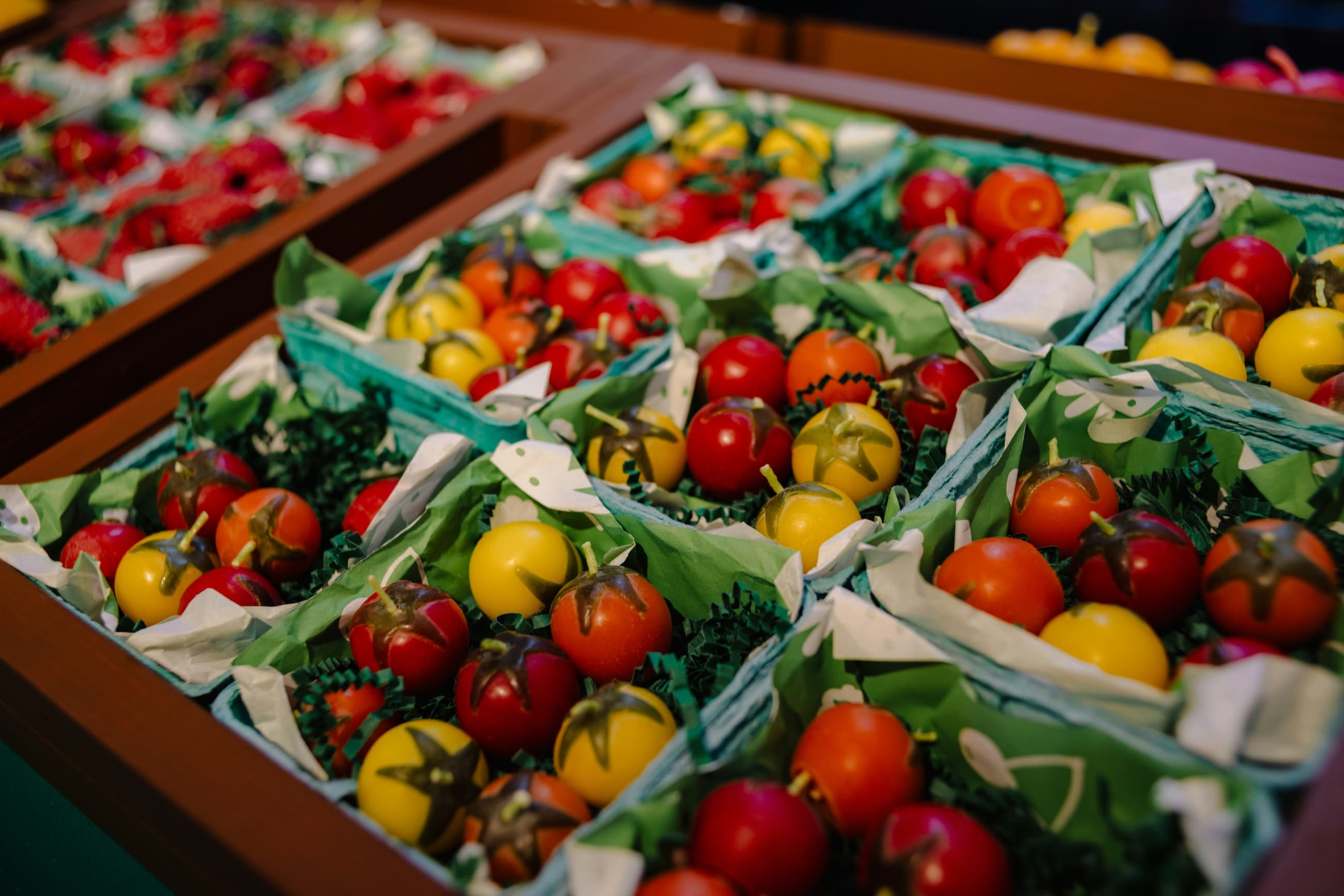 Punnets of tomatoes and peppers laid out for market.